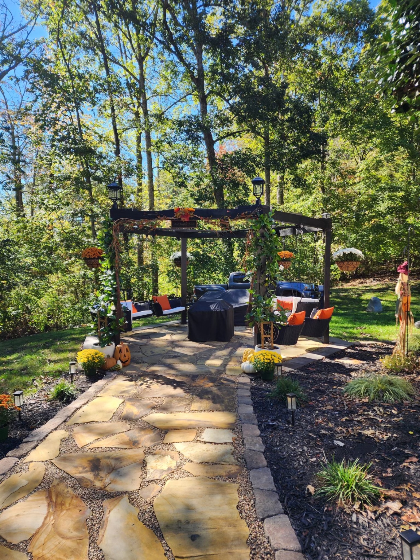 Flagstone patio with pergola and seasonal decor